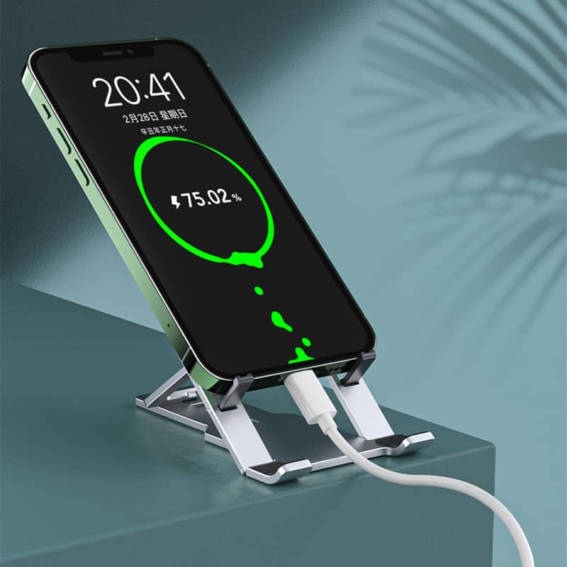 Giggly Gear adjustable aluminium tablet stand in silver holding a charging smartphone