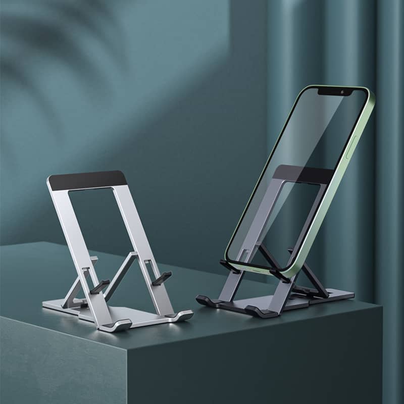 adjustable aluminium tablet stand in silver holding a smartphone on a grey surface