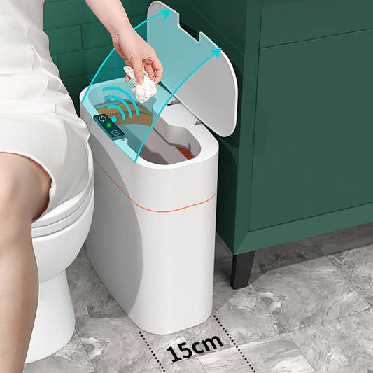 white compact sensor waste bin UK placed beside toilet with hands activating lid sensor